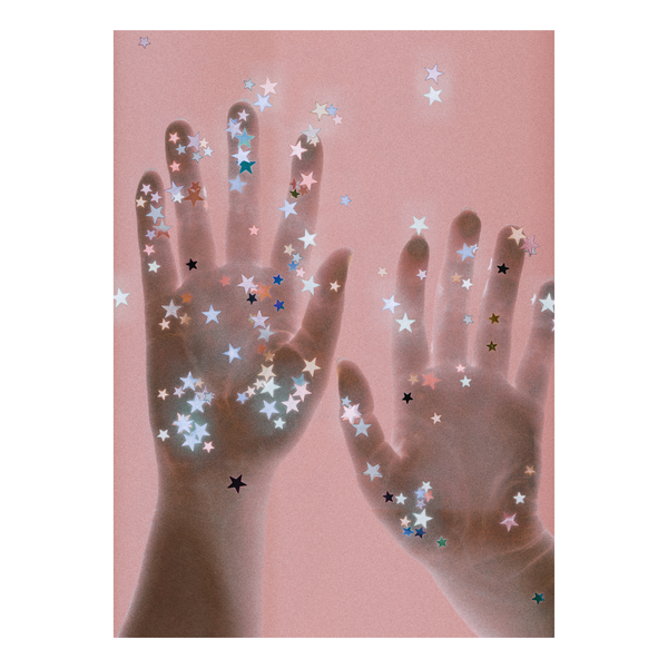 Handprints with star-shaped confetti on a beige background