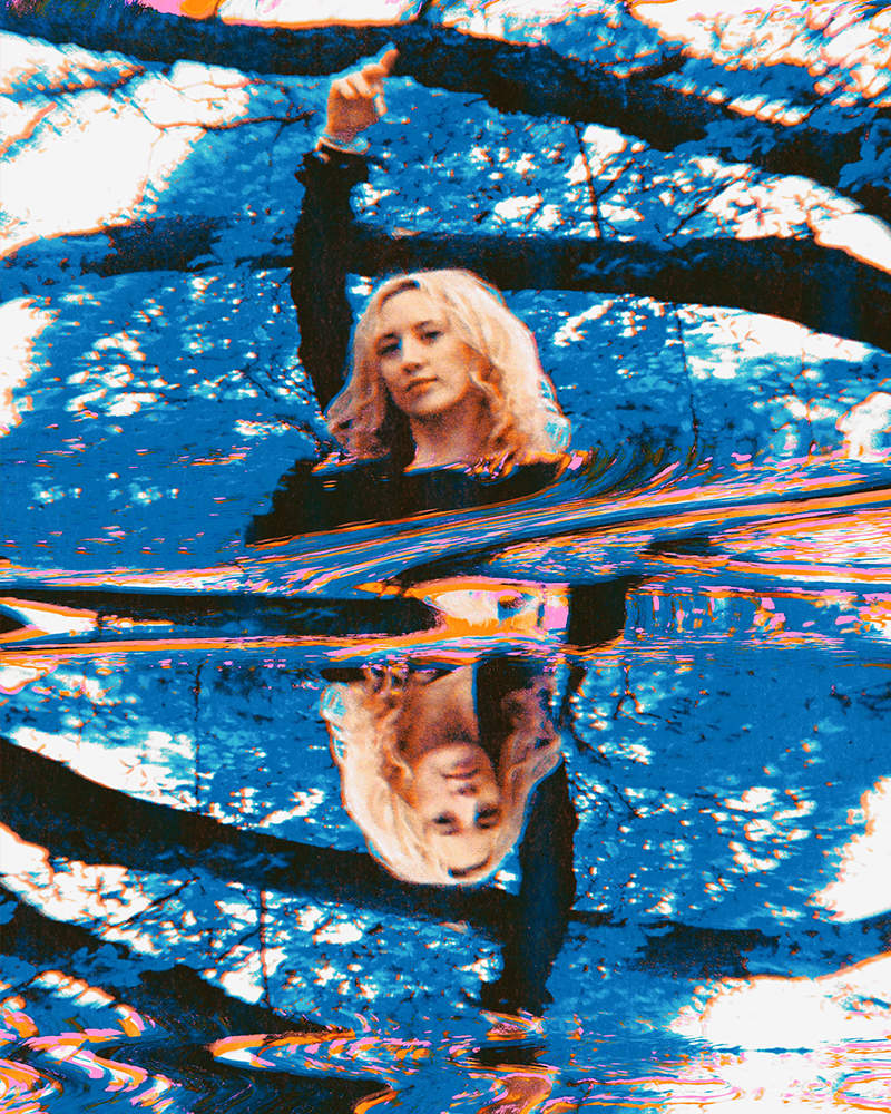 Hannah Telle centered in a glitchy, distorted style with her arms stretched upward, featuring a strong blue cast over the elements of the image.