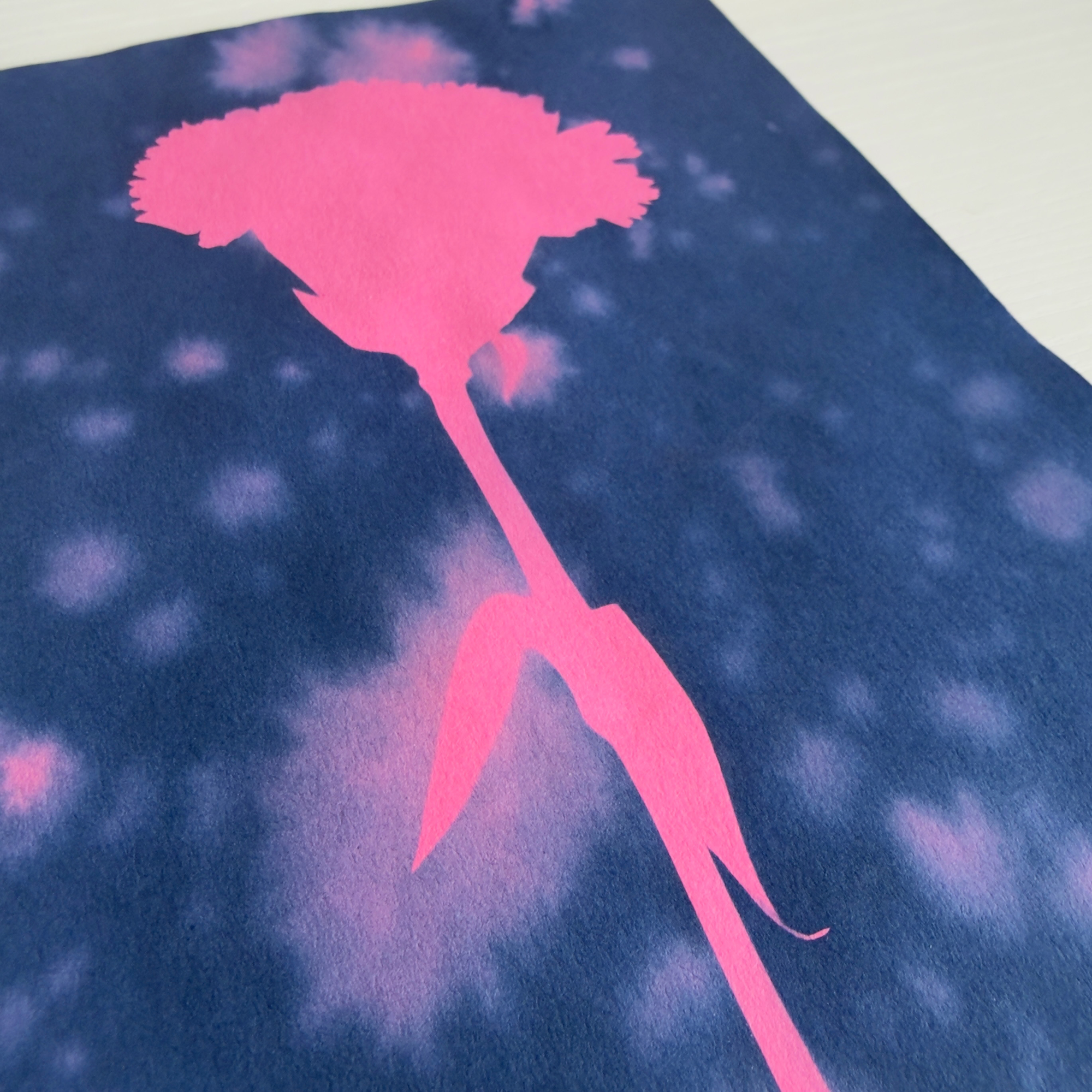Side view of a real life photo of a pink flower silhouette on a blue background